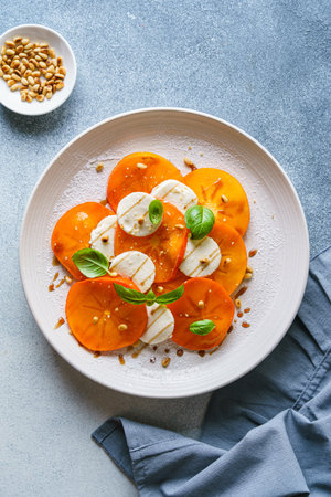 caprese salad with persimmon and mozzarella. High quality photoの写真素材