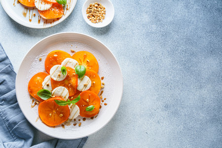 caprese salad with persimmon and mozzarella. High quality photoの写真素材