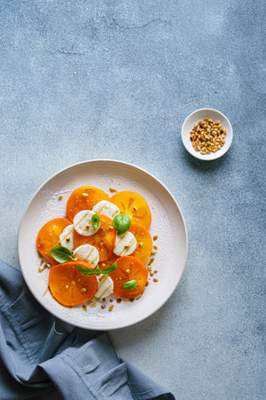 caprese salad with persimmon and mozzarella. High quality photoの写真素材
