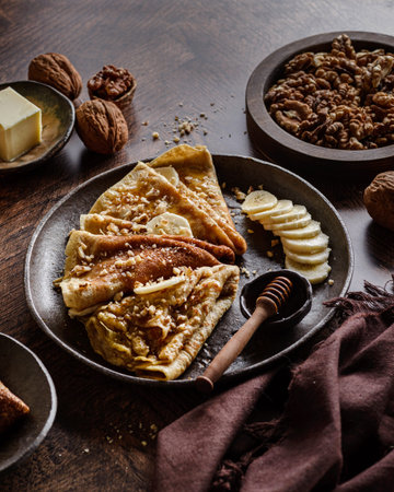 wholemeal crepes with honey, walnuts and bananas. High quality photoの写真素材