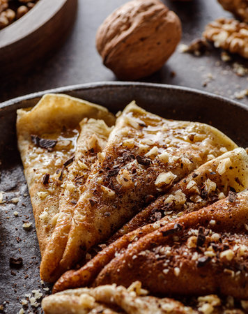 wholemeal crepes with honey, walnuts, banana and chocolate chips. Healthy food, vegetarianの写真素材