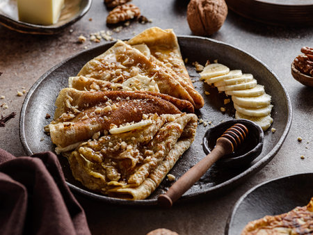 wholemeal crepes with honey, walnuts and bananas. High quality photoの写真素材