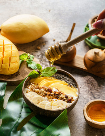 mango smoothie bowl with banana granola and chia seeds. High quality photoの写真素材