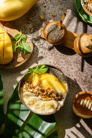 mango smoothie bowl with banana granola and chia seeds. High quality photoの写真素材