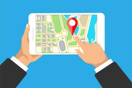 Hands holds tablet with map navigation on a screen. GPS navigator with red pinpoint. City map with...