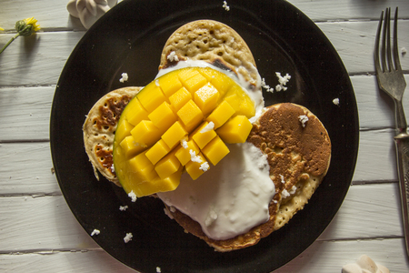 Pancakes with yoghurt and fresh mangoの写真素材