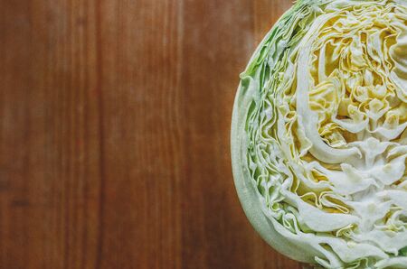 fresh cabbage top view on a wooden table. juicy white cabbage salad on a white plate. copy spaceの写真素材