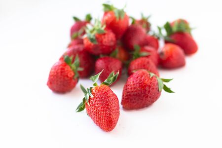 sweet red strawberries lying on a white background, organic food conceptの写真素材