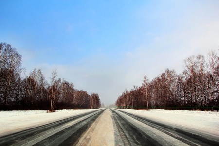 Image of winter road and cloudy skyの写真素材