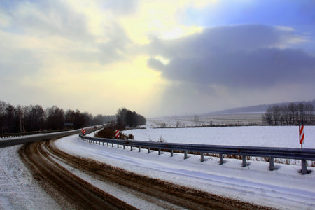 Image of winter road and cloudy skyの写真素材