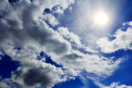 Image of the Sun and fluffy blue skyの写真素材