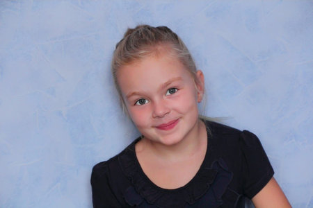 Portrait of beautiful girl with blond hair and blue eyes