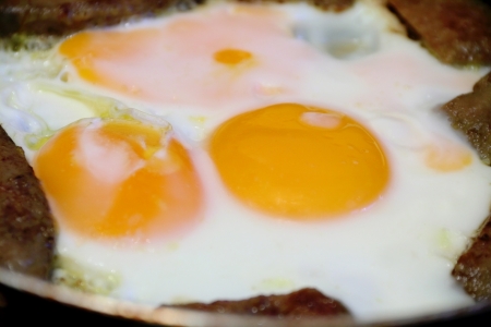 Image of fried eggs and meat for breakfastの写真素材