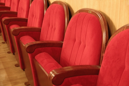Background of many red theatrical red chairsの写真素材