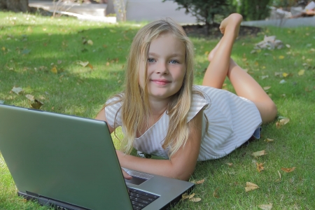 Image of girl with laptop in summerの写真素材