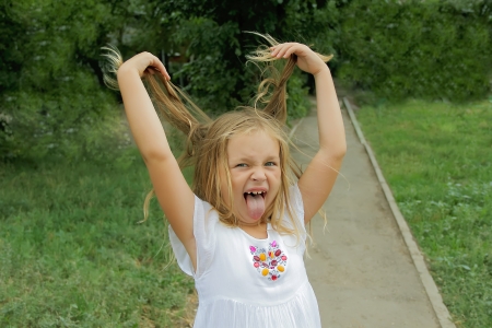 Portrait of girl with smile and makes facesの写真素材