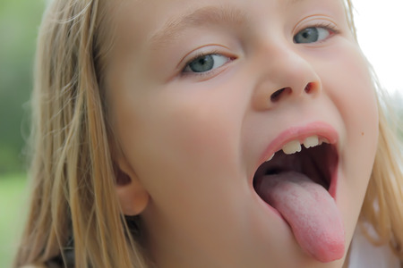 Portrait of girl with put out tongueの写真素材