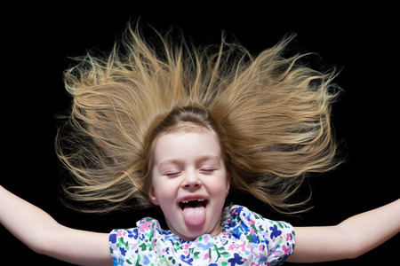 Girl makes faces imitate witch and put out tongueの写真素材