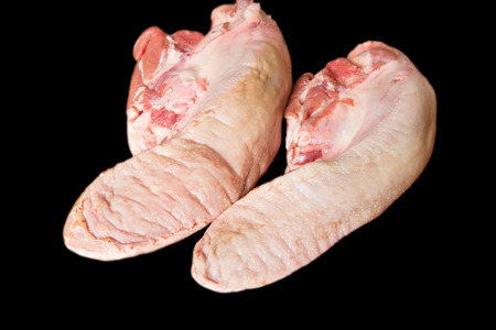 raw pork tongue on black backgroundの写真素材