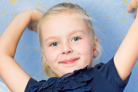 Cute girl seven years old with upward hands