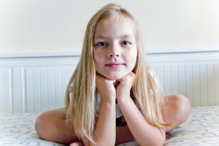 Cute girl with blond long hair and blue eyesの写真素材