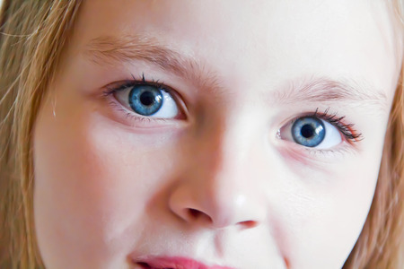 Cute girl with blond long hair and blue eyesの写真素材