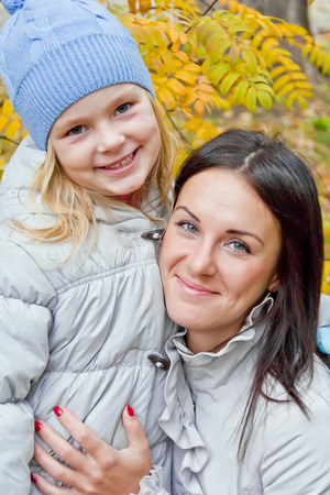 Photo of mother and daughter in autumnの写真素材