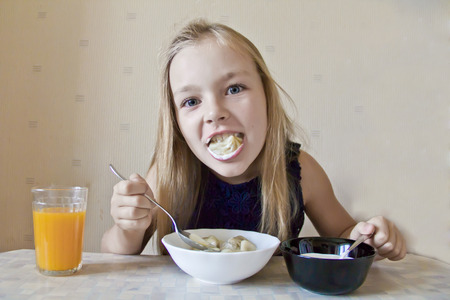 Photo of eating cute girl with blond hairの写真素材