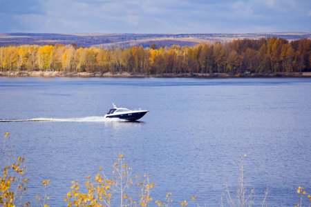 Photo of autumn landscape with motorboatの写真素材
