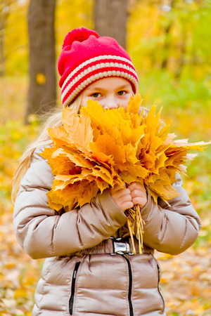 Photo of cute smiling girl in autumnの写真素材