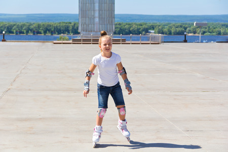 Photo of cute girl on roller skates in summerの写真素材