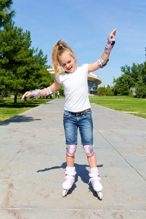 Photo of cute girl on roller skates in summerの写真素材