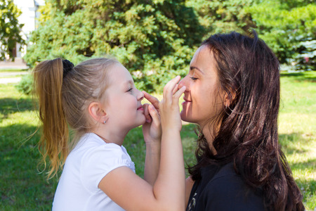 Photo of smiling playing mother and daughterの写真素材