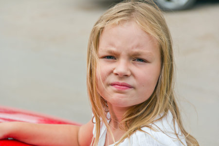 Cute girl with blond long hair and blue eyes