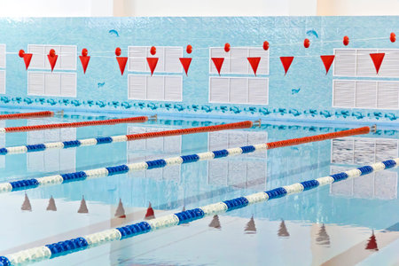 Photo of empty swimming pool with red flags