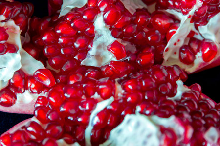 Photo of the dark red pomegranate is cut open
