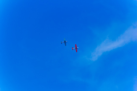 Photo of two flying planes in blue skyの写真素材