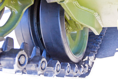 Caterpillar wheel of military machine at the exhibition under open sky