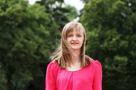 Blond smiling woman with long hair in summerの写真素材