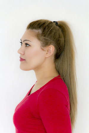 Ponytail Hairstyle. Beauty Fashion Model Girl with Long Healthy Straight Brown Hair. Beautiful Woman with brown long Healthy Smooth Straight hairの写真素材