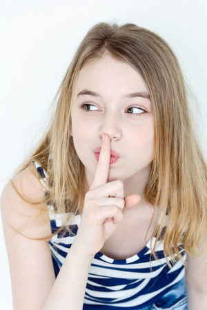 Portrait of girl eleven years old with big green eyes says quietの写真素材