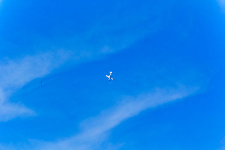 Photo of flying military airplane in blue skyPhoto of flying military airplane in blue sky with...
