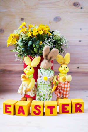 Easter composition with bunnies, flowers and blocksの写真素材