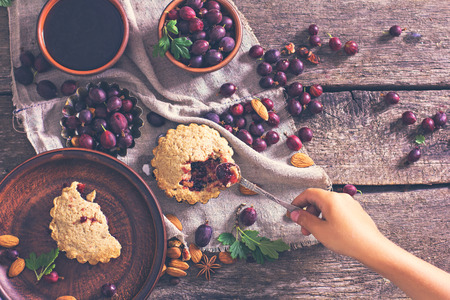 Pie with gooseberry. Rustic style. pie with fresh garden berries over grunge rusty metal background, top view, copy space. Summer pie with berries.の写真素材