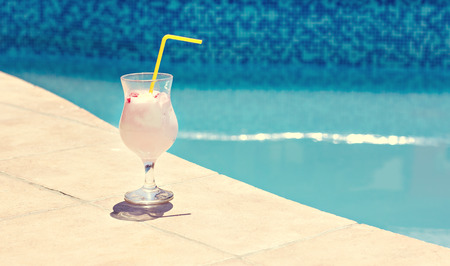 Summer cocktail on the background of the pool. Pina colada, milk cocktail, berry cocktail. Summer vacation, relaxation, summer party.の写真素材