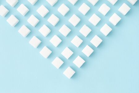 Sugar cubes geometry pattern on pastel blue background with copy space. Abstract, flat lay, minimal style.の写真素材