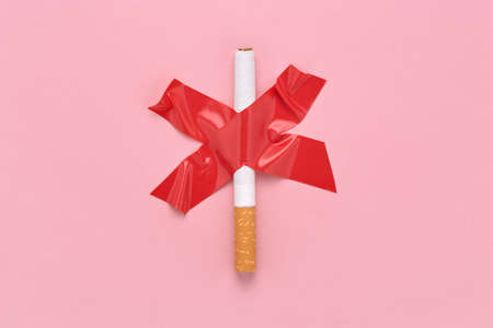 Red cross sign glued a cigarette, No smoking symbol.の写真素材