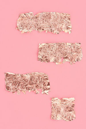 Rose gold scraps on pink background, copy space, design template.