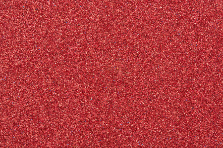 Red glittering paper texture. Smooth abstract background. Sparkle overlay for design, close-up.