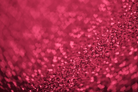 Red Viva Magenta glitter background with hearts bokeh for Valentines day.